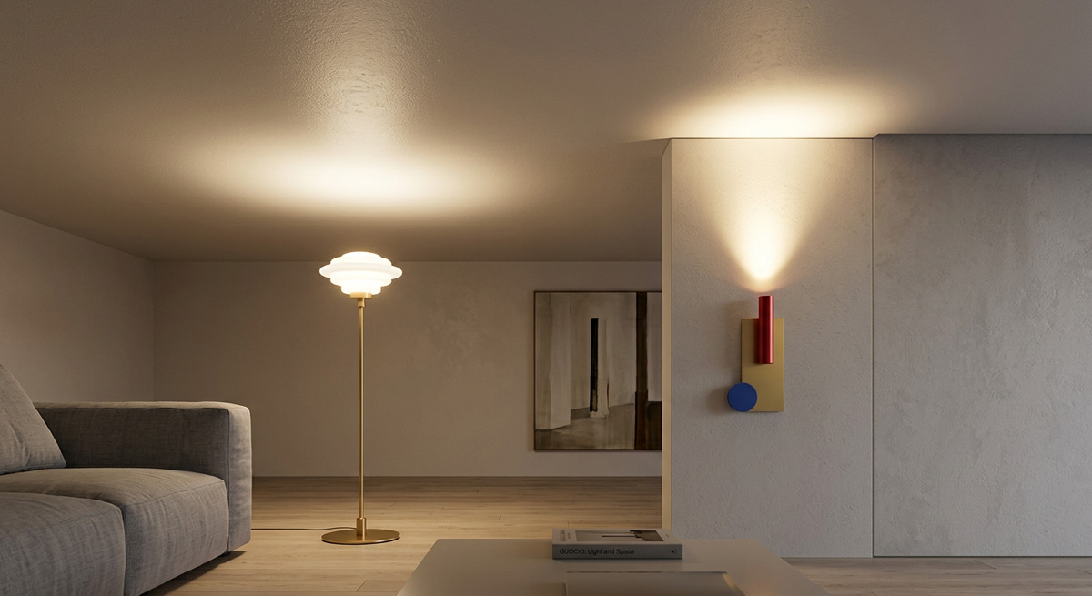 A Guocio wall lamp and floor lamp casting light upwards, visually expanding the height of a low ceiling.
