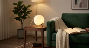 A perfectly proportioned Guocio table lamp placed next to a sofa, demonstrating ideal living room lighting design.